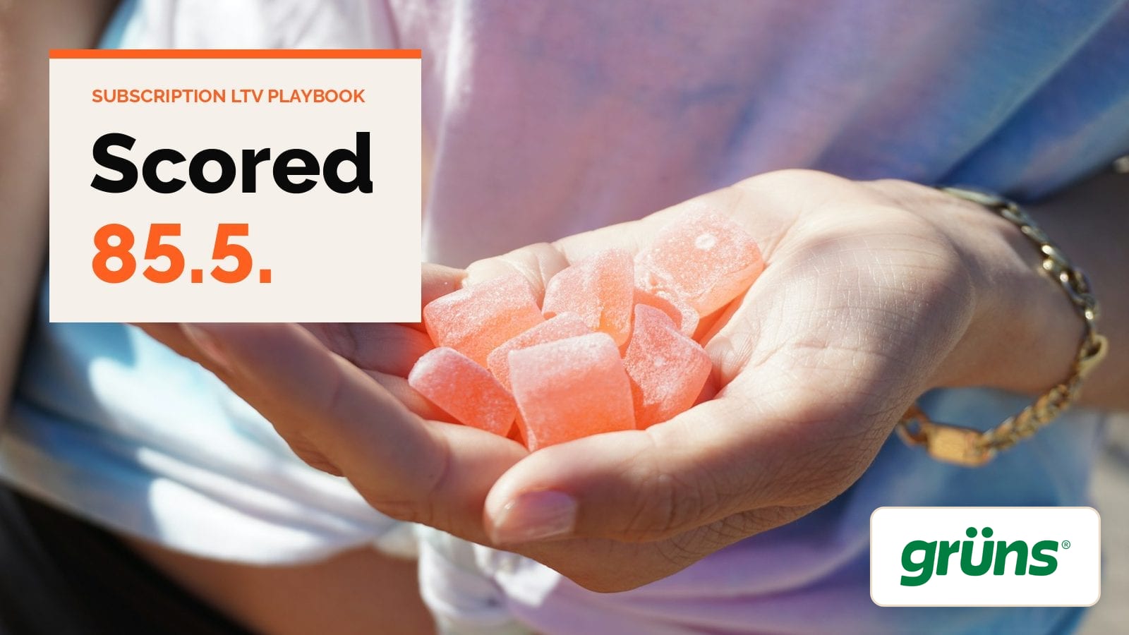 An open hand holding a pile of pink gummies