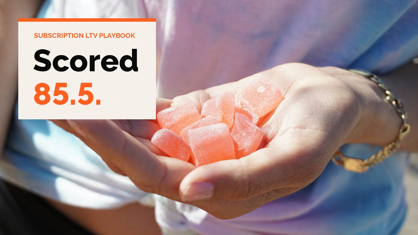 An open hand holding a pile of pink gummies