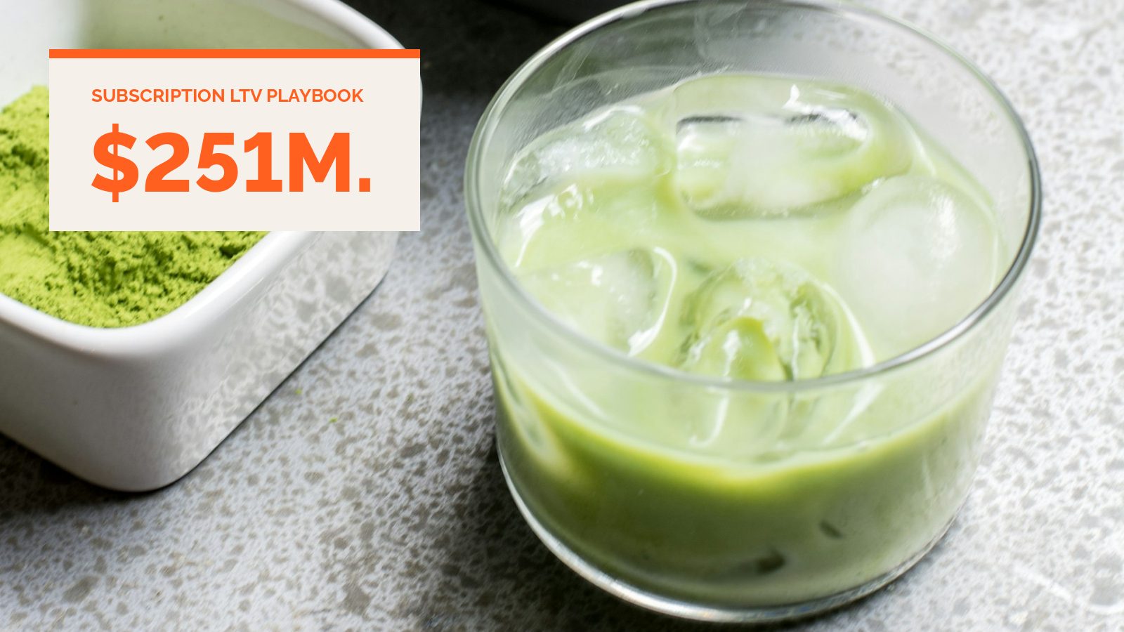 A dish of green powder next to a glass of iced green drink