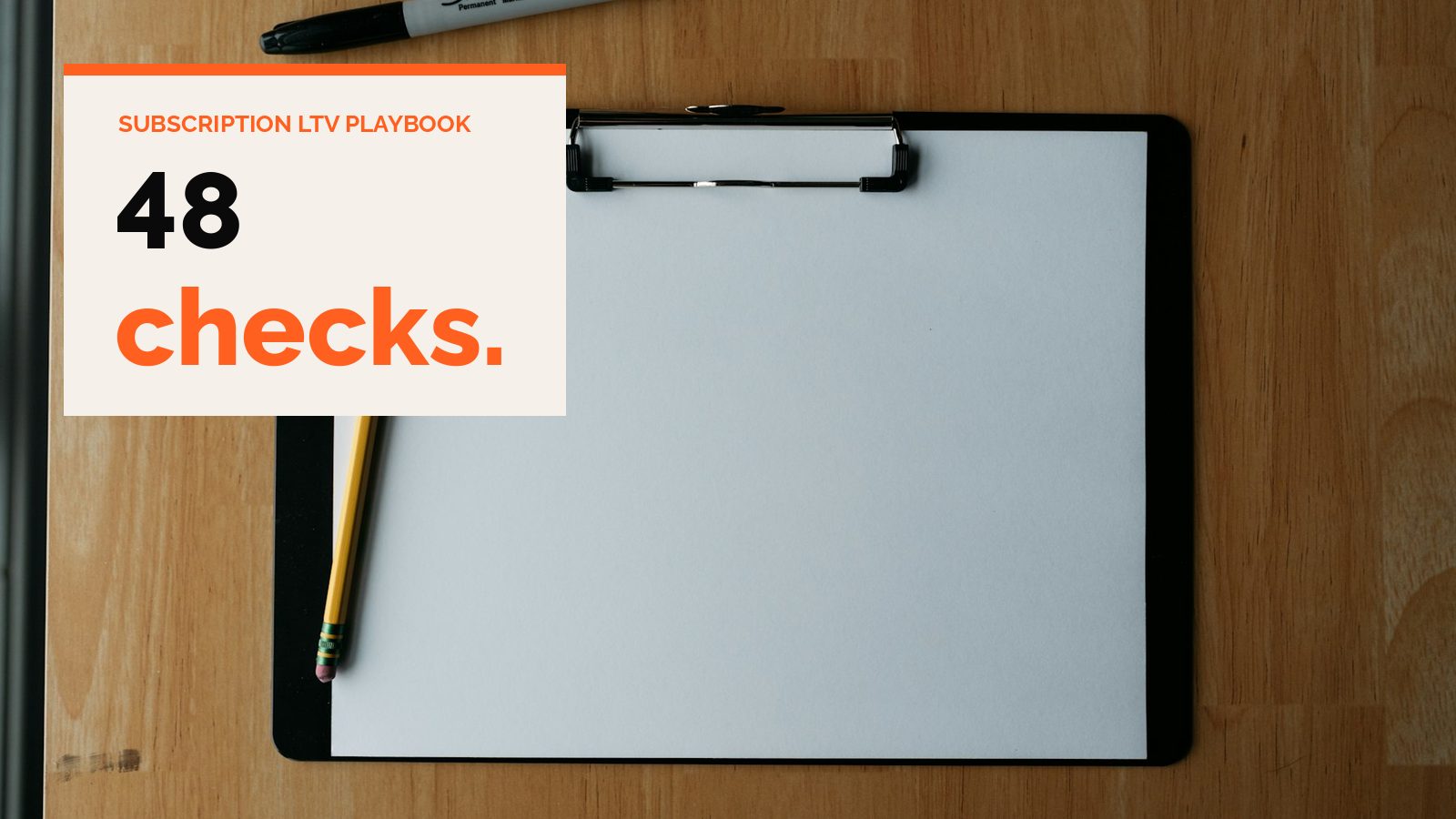 A blank clipboard with a pencil on a wooden desk