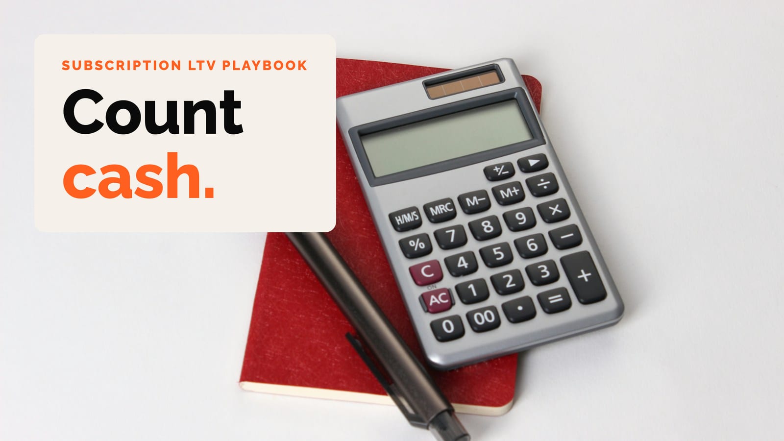 A calculator and pen on a red notebook, with the words Count cash
