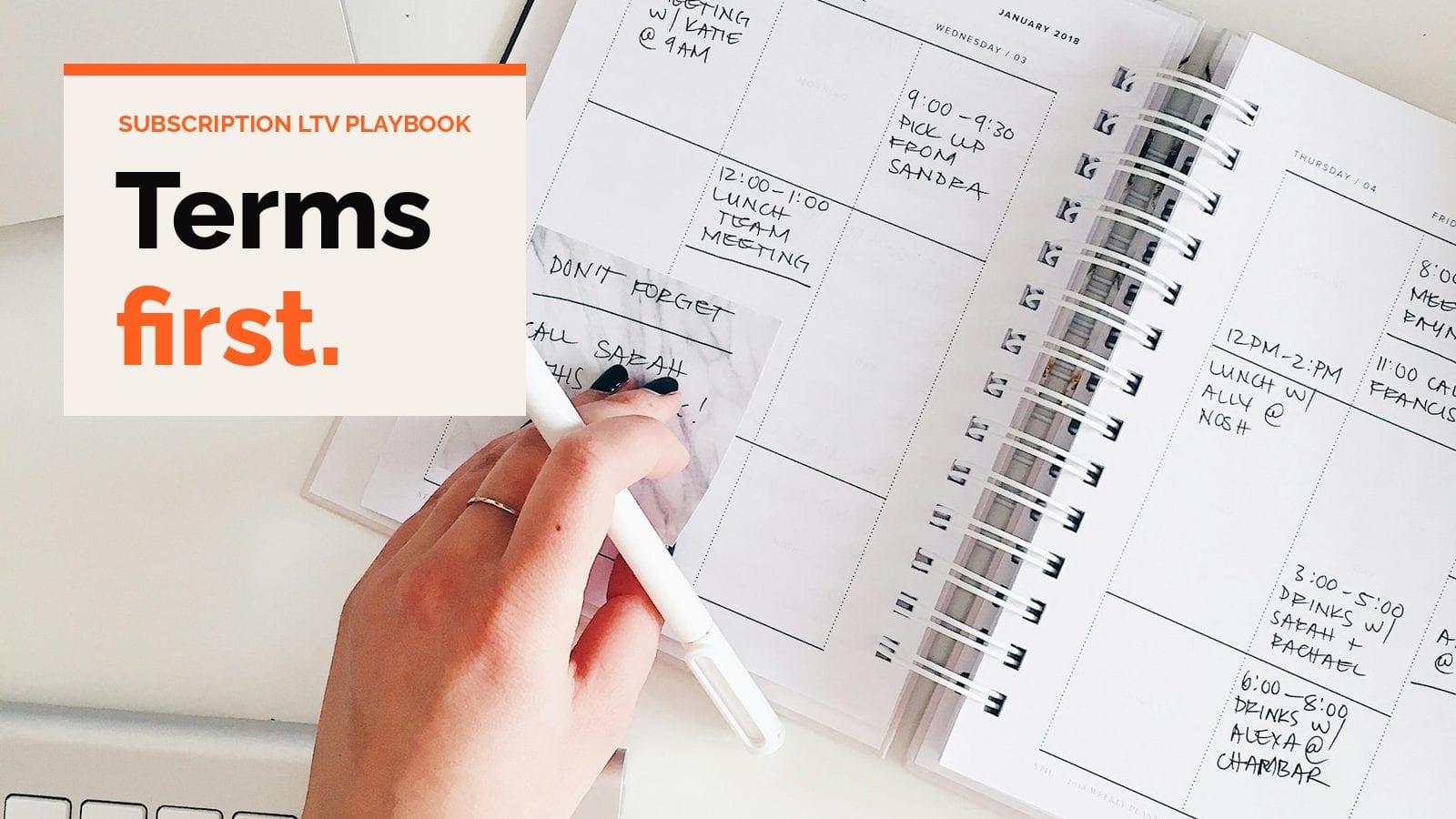A hand writing in a weekly planner with a stylus