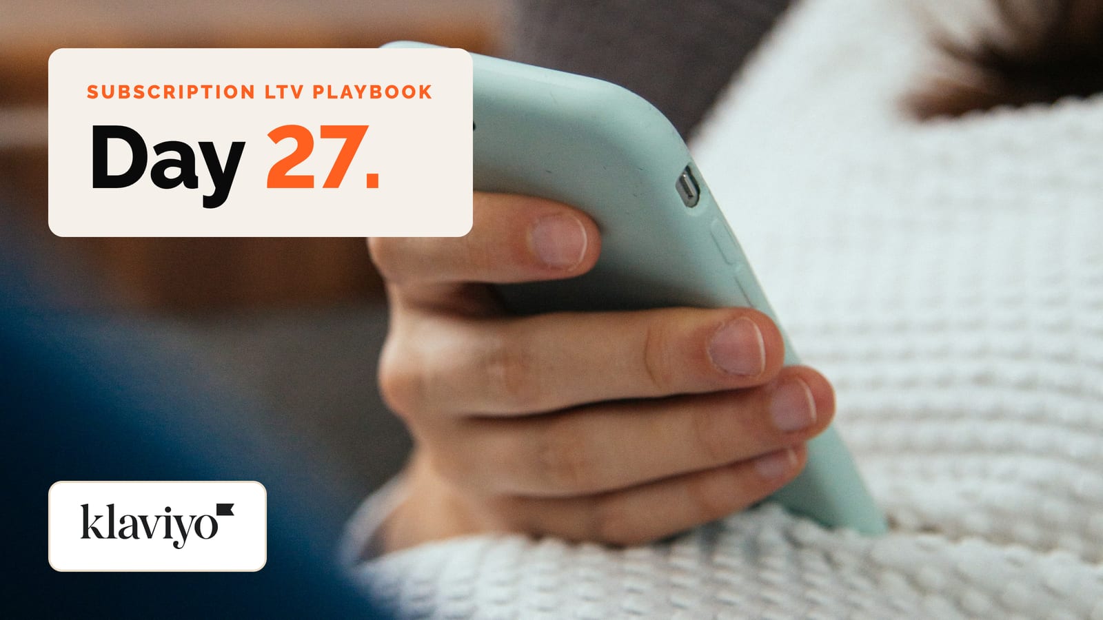 Hand holding a phone, with a Day 27 hook panel and the Klaviyo logo